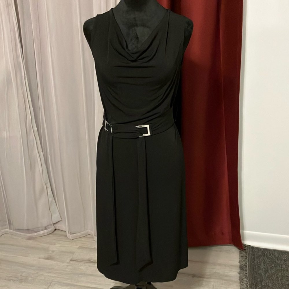 A little black dress with a strap at the waist.